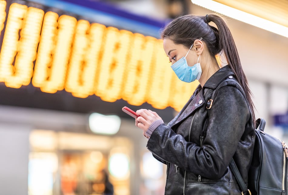 Person checking mobile phone at airport