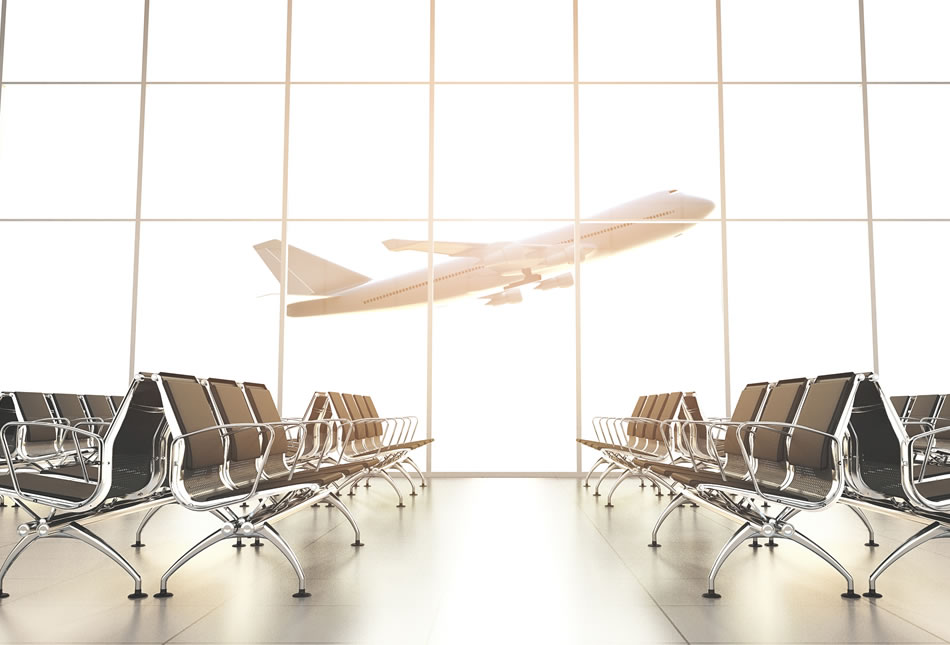 View of aircraft taking off through window of airport terminal waiting area.